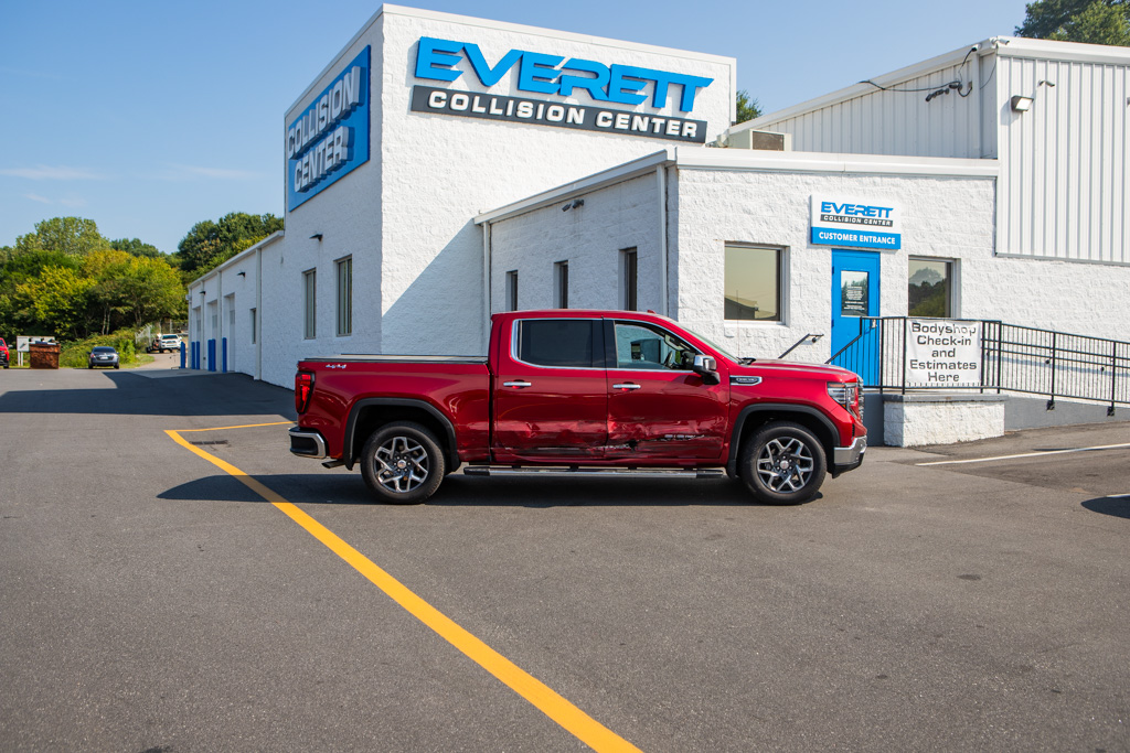 Red damaged truck in front of Collision Center